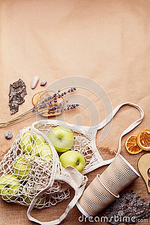 Natural, eco-friendly, zero waste background. Eco shopping bag with apples among bark tree, pebbles. Sustainable Stock Photo