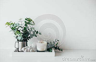 Natural eco home decor with green leaves and burning candle on t Stock Photo