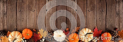 Natural fall border with pumpkins and leaves on a rustic dark wood banner background Stock Photo