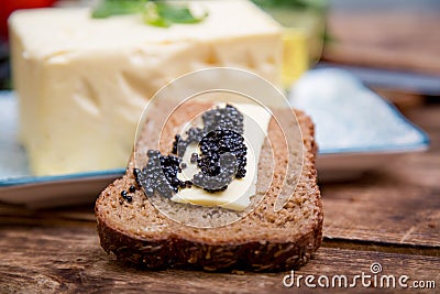 Natural food and ingredients, breakfast with butter, bread and black caviar Stock Photo