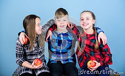 Natural food will do you good. Small group of little children holding natural red apples. Natural joy in healthy eating Stock Photo