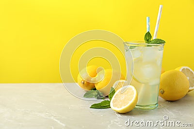 Natural freshly made lemonade on grey marble table, space for text. Summer refreshing drink Stock Photo