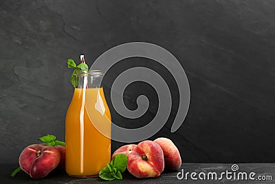 Natural freshly made peach juice on grey table. Space for text Stock Photo