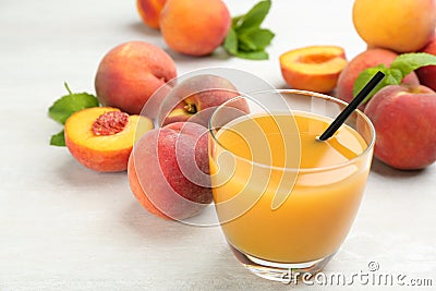 Natural freshly made peach juice on white table, closeup Stock Photo