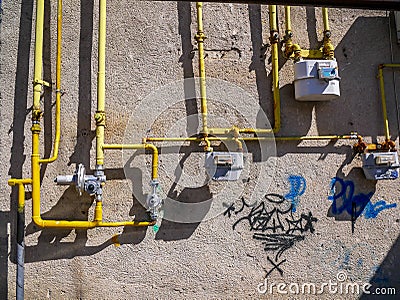 Natural gas meters and pipes on old dirty wall. Editorial Stock Photo