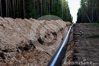 Natural gas pipeline construction work. A dug trench in the ground for the installation and installation of industrial gas and oil Stock Photo