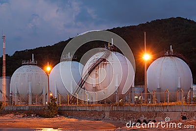 Natural gas storage tank in sphere shape at twilight time Stock Photo