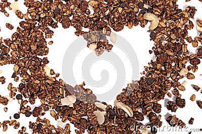 Natural granola heart with oatmeal, nuts, fruits and chocolate. The concept of healthy food, diet, weight loss Stock Photo