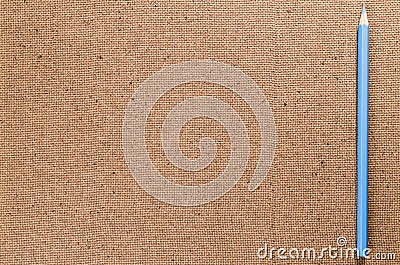 Natural hardboard surface with blue pencil - copy space Stock Photo