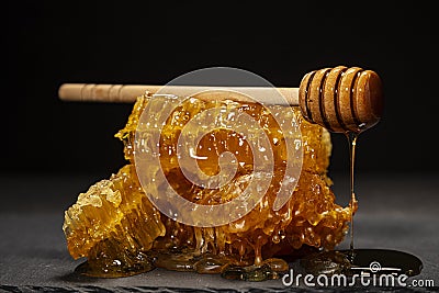 Natural Honeycombs with Honey Dripper Stock Photo
