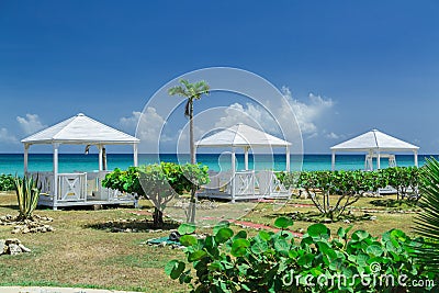 Natural landscape view with beautiful inviting gorgeous massage gazebos near the beach and ocean Stock Photo