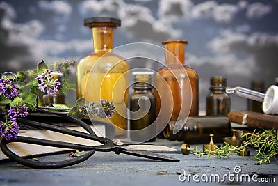 Natural medicine, healing herbs, scissors and apothecary bottles Stock Photo