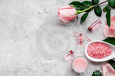 Natural organic cosmetics with rose oil. Cream, lotion, spa salt on grey background top view copyspace Stock Photo