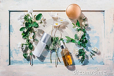 Natural organic cosmetics: serum, cream, mask on wooden background with flowers. Skincare concept Stock Photo