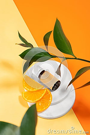 Natural organic vitamin C essential oil of orange and a slice of fruit laying on a tangerine background. Healthy skin, anti-stress Stock Photo
