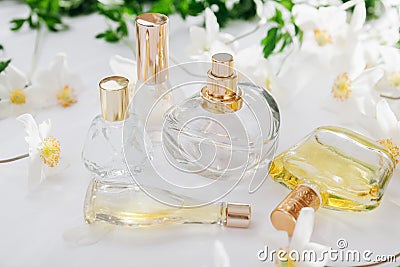 Natural perfume concept. Bottles of perfume with white flowers. Floral fragrance Stock Photo