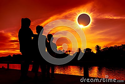 Natural phenomenon. Three looking at looking at total solar eclipse. Stock Photo