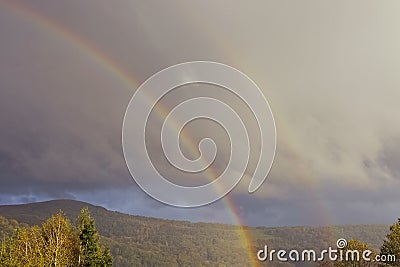 Natural rainbow and cloudy sky Stock Photo