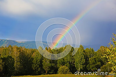 Natural rainbow in the mountains Stock Photo