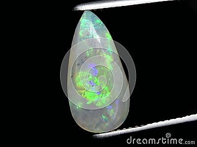 natural rainbow multi color opal gem on the background Stock Photo