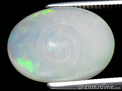 natural rainbow multi color opal gem on the background Stock Photo