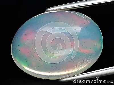 natural rainbow multi color opal gem on the background Stock Photo