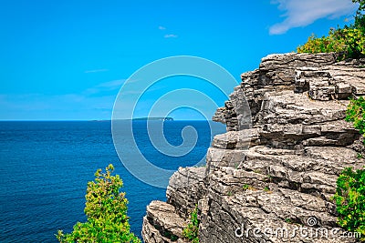 Natural rocky cliff, landscape view above tranquil azure blue water at beautiful, inviting Bruce Peninsula, Ontario Stock Photo