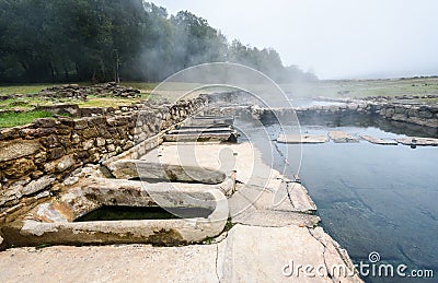 Natural Roman baths outdoors with hot steam and thermal water Stock Photo