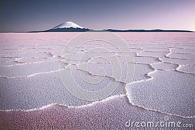 Natural Salt Flats Desert and a Snow Capped Dormant Volcano at Dusk Stock Photo