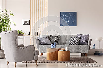 Natural scandinavian living room interior with wooden furniture, mockup picture on empty white wall Stock Photo