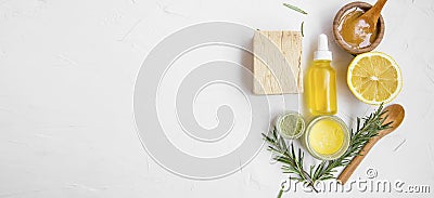 Natural skincare ingredients with manuka honey, lemon, essential oil, clay, balm, rosemary herbs and natural soap with copy space Stock Photo