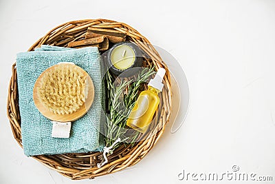 Natural spa skincare and beauty products. Rosemary herb, oil bottle, body brush and towel, top view of spa products with natural Stock Photo