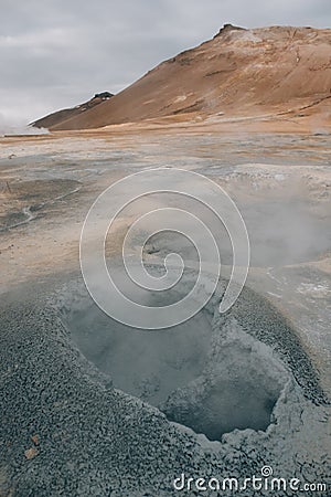 Natural steam rising from volcanic vents in the earth at Hverir in Iceland near Stock Photo