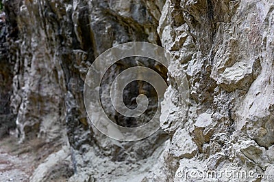 Natural stony background of part of rock formation with uneven surface. Stock Photo