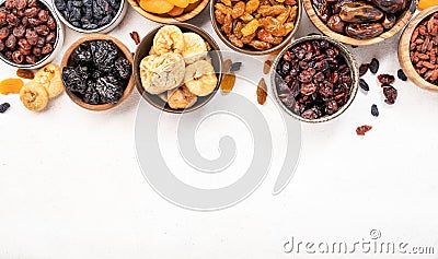 Natural sun dried fruits assortment in bowls on white background. Healthy wholesome snacks. Copy space Stock Photo
