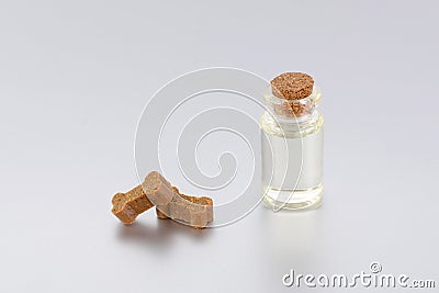 Natural supplement oil for pets with treats like bones Stock Photo