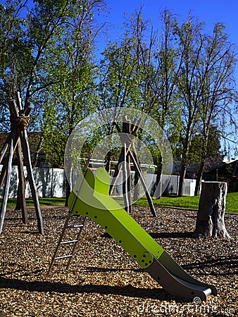 Natural toddler playground with green slide Stock Photo