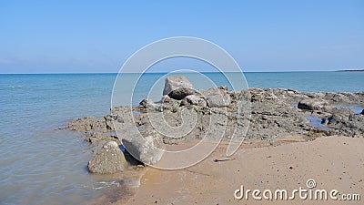 Pile Of Rocks On The Edge Of Tanjung Kalian Beach, Indonesia Stock Photo