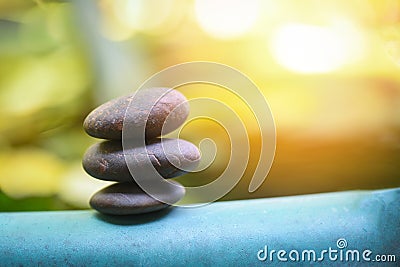Natural wellness concept - Relax zen stones stack on wooden nature green background Spa Natural Alternative Therapy With Massage Stock Photo
