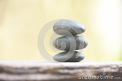 Natural wellness concept - Relax zen stones stack on wooden nature green background Spa Natural Alternative Therapy With Massage Stock Photo