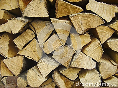 Natural wooden background. Firewood stacked and prepared for winter Pile of wood logs. Stock Photo