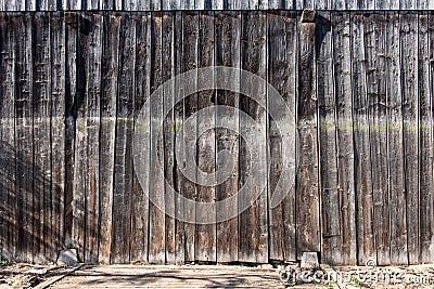 Natural, wooden, brown boards, wall of a barn, fence with branches and knotholes, abstract textured background, Stock Photo