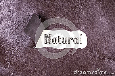 Natural word written on torn leather Stock Photo