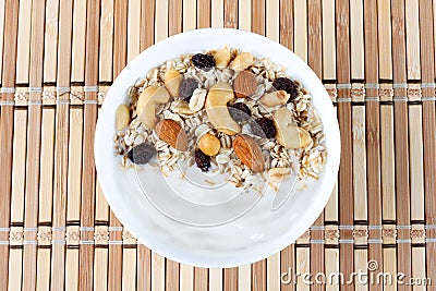 natural yogurt with homemade granola and nuts in ceramic bowl on a table top view Stock Photo