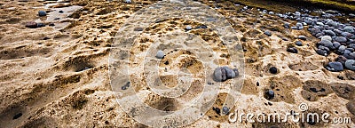 Nature background of stones and depressions carved in the rock on sea shore Stock Photo