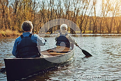 Nature is calling and we must go. a senior couple going for a canoe ride on the lake. Stock Photo