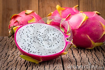 Nature can be pretty weird sometimes, Dragon-fruit are nutritious tropical fruit That way your fruits setup on wooden background. Stock Photo