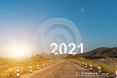 Nature landscape with asphalt road leading forward to happy new year 2021. Stock Photo