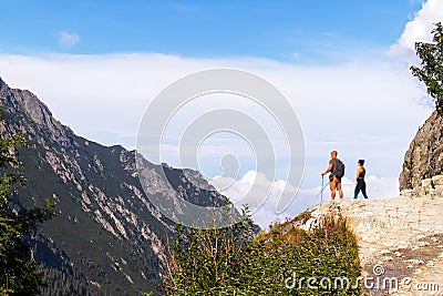 Natural landscape with mountains in the Polish Tatras with two people on the side of the mountain Editorial Stock Photo