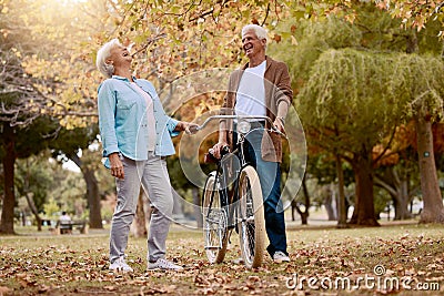 Nature, laugh and senior couple with bicycle to travel in autumn park for funny romantic date, outdoor peace or freedom Stock Photo